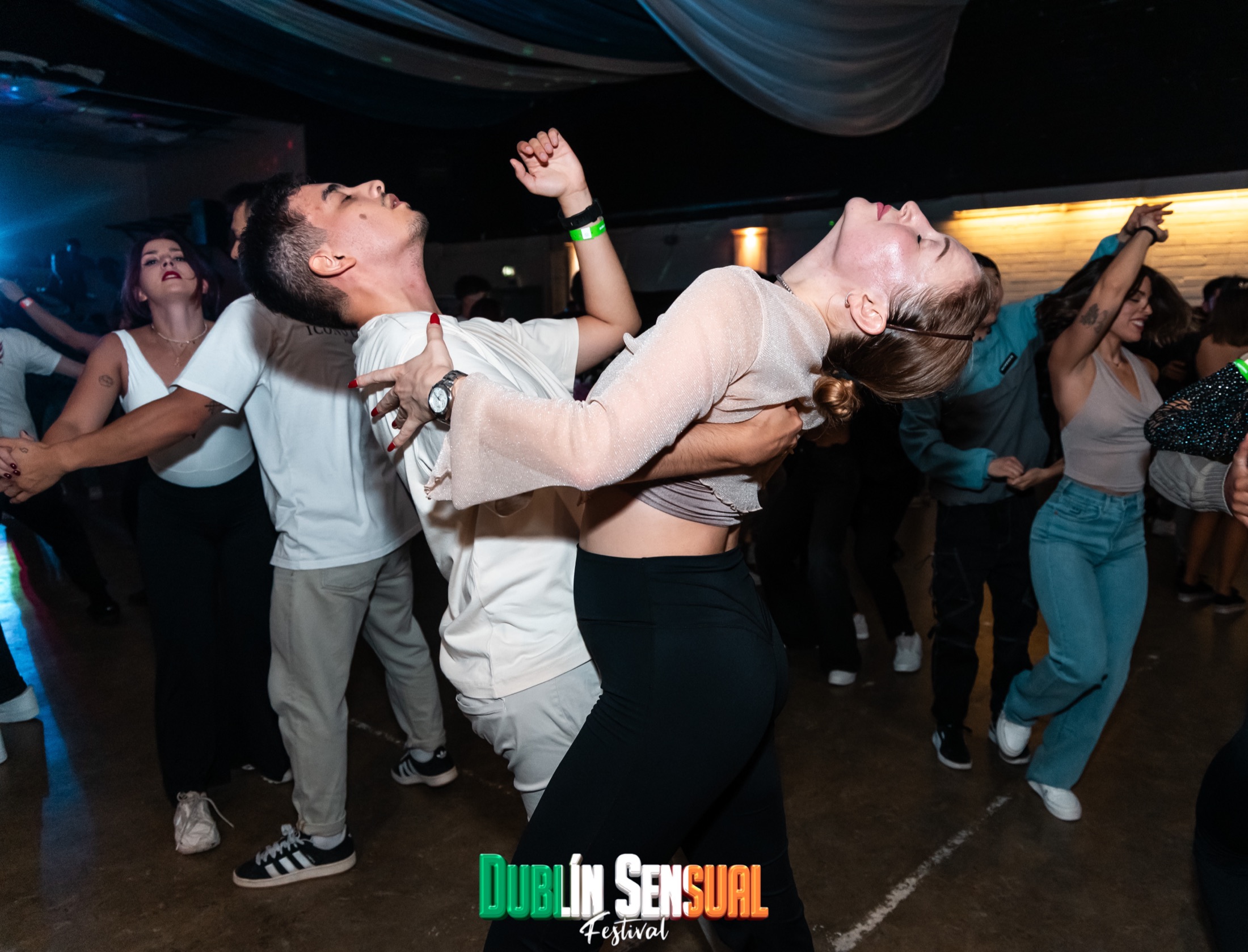 A couple dancing Bachata on a busy festival dance floor